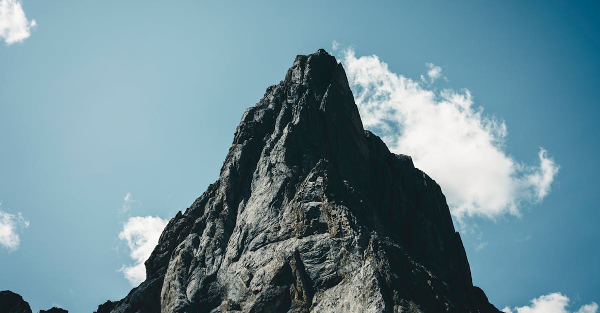 Stunning view of a rocky mountain peak under a clear blue sky in Banff, Alberta.